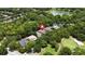 An aerial view of a house surrounded by lush greenery, near a pond and golf course at 207 Spalding Way, Deland, FL 32724