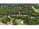 An aerial view of a house surrounded by lush greenery and golf course at 207 Spalding Way, Deland, FL 32724