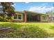 The backyard features a screened-in patio and is surrounded by lush landscaping providing a relaxing outdoor space at 207 Spalding Way, Deland, FL 32724