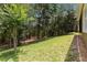 This backyard offers ample green space and privacy with its mature trees and natural surroundings at 207 Spalding Way, Deland, FL 32724