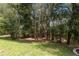 This backyard features mature trees offering privacy and a serene natural setting at 207 Spalding Way, Deland, FL 32724