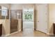 Bright bathroom featuring a tiled shower, neutral colors, and access to a bedroom at 207 Spalding Way, Deland, FL 32724