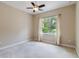 Neutral bedroom with carpet, ceiling fan, and a window bringing in lots of natural light at 207 Spalding Way, Deland, FL 32724