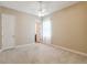 Neutral bedroom with carpet, ceiling fan, and ensuite bathroom access at 207 Spalding Way, Deland, FL 32724