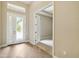 Entryway with tiled floor and decorative glass door, leading to an open and airy floor plan at 207 Spalding Way, Deland, FL 32724