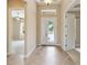 Spacious foyer featuring tiled floors, high ceilings, decorative glass front door, and an open view to other rooms at 207 Spalding Way, Deland, FL 32724