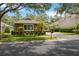 Inviting single-story home with manicured landscaping, lush green lawn, and mature trees for added privacy at 207 Spalding Way, Deland, FL 32724