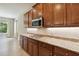 Kitchen showcasing granite countertops and dark wood cabinets with stainless appliances at 207 Spalding Way, Deland, FL 32724