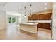 Bright kitchen with an island, stainless steel appliances, and sleek cabinetry for a modern touch at 207 Spalding Way, Deland, FL 32724