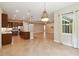 Kitchen features granite countertops, wooden cabinets, stainless appliances, and an island at 207 Spalding Way, Deland, FL 32724