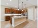 Kitchen featuring granite countertops, an island, stainless appliances, and wooden cabinetry at 207 Spalding Way, Deland, FL 32724