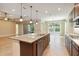 Open layout kitchen with island, stainless appliances, and seamless view to the outside at 207 Spalding Way, Deland, FL 32724