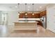 Spacious kitchen features an island, stainless steel appliances, and sleek wooden cabinetry at 207 Spalding Way, Deland, FL 32724