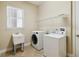 Laundry room with washer, dryer, sink, and window for natural light at 207 Spalding Way, Deland, FL 32724