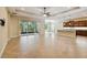Open-concept living space with tile flooring, modern lighting, and sliding glass doors to bring in natural light at 207 Spalding Way, Deland, FL 32724