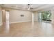 Expansive living room featuring tile floors, high ceilings, and sliding glass doors to enjoy views of the outdoors at 207 Spalding Way, Deland, FL 32724