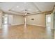 Open living area with a tray ceiling, tile floors, and easy access to the outdoor area and other rooms at 207 Spalding Way, Deland, FL 32724