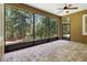 Screened-in patio with stone flooring and views of the surrounding trees at 207 Spalding Way, Deland, FL 32724