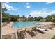 Community pool with lounge chairs offers a refreshing oasis for relaxation and recreation at 207 Spalding Way, Deland, FL 32724