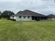 Spacious backyard featuring a covered patio area perfect for outdoor living and entertaining at 23717 Milford Dr, Eustis, FL 32736