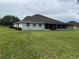 Spacious backyard featuring a covered patio area perfect for outdoor living and entertaining at 23717 Milford Dr, Eustis, FL 32736