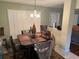 Intimate dining area with a table, and shuttered windows, and a view of the living areas of the home at 23717 Milford Dr, Eustis, FL 32736