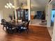 Formal dining room with wood flooring, ornate china cabinet, chandelier, and seamless flow into the living spaces at 23717 Milford Dr, Eustis, FL 32736