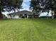 Charming single-story home featuring a well-manicured lawn and mature trees enhancing curb appeal at 23717 Milford Dr, Eustis, FL 32736