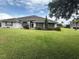 Charming single-story home featuring a well-manicured lawn and mature trees enhancing curb appeal at 23717 Milford Dr, Eustis, FL 32736