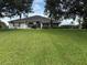 Charming single-story home featuring a well-manicured lawn and mature trees enhancing curb appeal at 23717 Milford Dr, Eustis, FL 32736