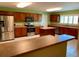 Spacious kitchen featuring a center island, and stainless-steel appliances, perfect for Gathering gatherings and meal preparation at 23717 Milford Dr, Eustis, FL 32736