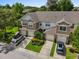 Aerial view of townhouses, manicured lawns, attached garages, and ample parking at 2420 Stockton Dr, Sanford, FL 32771