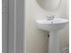 Clean bathroom featuring a pedestal sink and tiled floors at 2420 Stockton Dr, Sanford, FL 32771