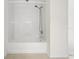 A clean bathtub with shower, white tub surround and tile flooring in bathroom at 2420 Stockton Dr, Sanford, FL 32771