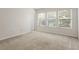 Bright, carpeted bedroom with neutral walls and multiple windows for abundant natural light at 2420 Stockton Dr, Sanford, FL 32771