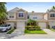 Inviting townhouse showcasing well-maintained landscaping and attached garages at 2420 Stockton Dr, Sanford, FL 32771