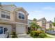 Townhouse with stucco exterior, an attached garage, and meticulously manicured landscaping at 2420 Stockton Dr, Sanford, FL 32771