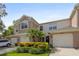 Charming townhouse featuring an attached garage, lush landscaping, and a manicured lawn at 2420 Stockton Dr, Sanford, FL 32771