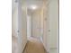 Hallway leading to bedrooms and bathrooms featuring neutral walls and carpeted floor at 2420 Stockton Dr, Sanford, FL 32771