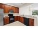 Well-equipped kitchen with microwave, oven, dishwasher, and view of the breakfast nook at 2420 Stockton Dr, Sanford, FL 32771