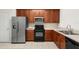 Efficient kitchen with stainless refrigerator, built in microwave, oven, and double basin sink at 2420 Stockton Dr, Sanford, FL 32771