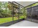 Enclosed lanai showcasing the lush backyard and well maintained landscaping at 2420 Stockton Dr, Sanford, FL 32771