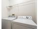 Laundry room featuring a washer and dryer with overhead wire shelving for storage at 2420 Stockton Dr, Sanford, FL 32771