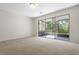 Bright living room with neutral carpet and access to the screened lanai at 2420 Stockton Dr, Sanford, FL 32771