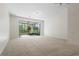 Spacious living room with carpeted flooring and access to the screened-in lanai at 2420 Stockton Dr, Sanford, FL 32771