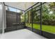 View of the screened porch overlooking the well maintained lawn and garden at 2420 Stockton Dr, Sanford, FL 32771