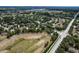 A charming residential neighborhood with tree-lined streets and beautifully maintained homes from an aerial view at 2426 Breezy Meadow Rd, Apopka, FL 32712