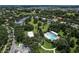 Aerial view of a home's pool and of the surrounding neighborhood with trees at 2426 Breezy Meadow Rd, Apopka, FL 32712