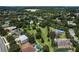 Aerial view of the neighborhood, with a pool and homes surrounded by trees at 2426 Breezy Meadow Rd, Apopka, FL 32712