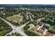 Aerial view showing the neighborhood with mature trees, homes, a retention pond, and nearby community park at 2426 Breezy Meadow Rd, Apopka, FL 32712